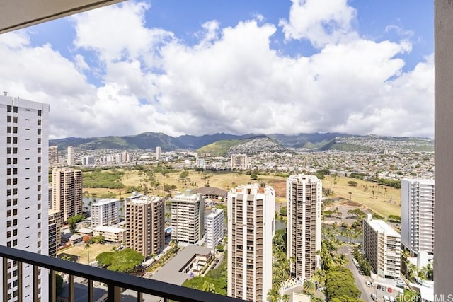 balcony featuring a city view and a mountain view