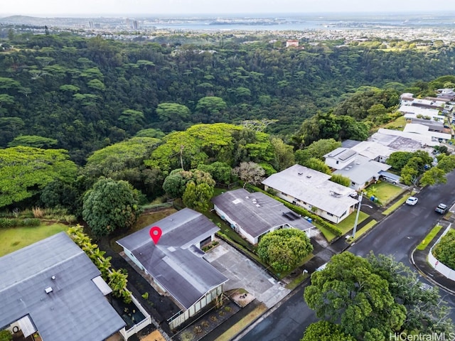 birds eye view of property featuring a wooded view