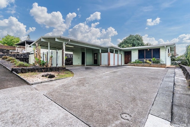 ranch-style house with fence and driveway