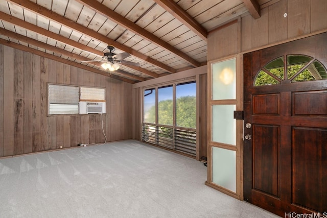 entryway with light carpet, wooden walls, wooden ceiling, and vaulted ceiling with beams