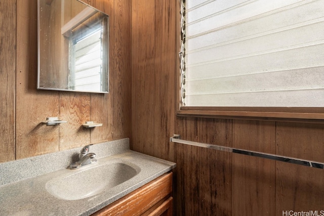 bathroom with wooden walls and vanity