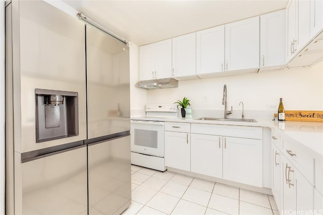 kitchen featuring white electric stove, a sink, white cabinets, under cabinet range hood, and stainless steel fridge