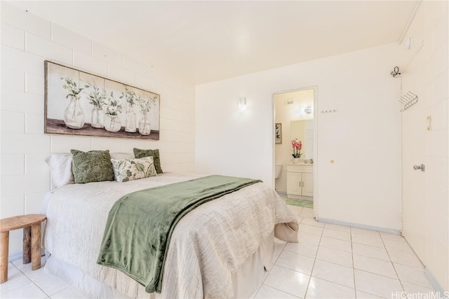 bedroom featuring light tile patterned floors and ensuite bathroom