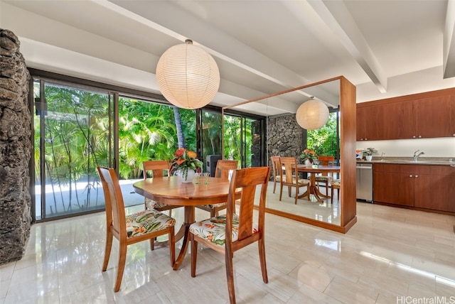 dining space featuring beamed ceiling