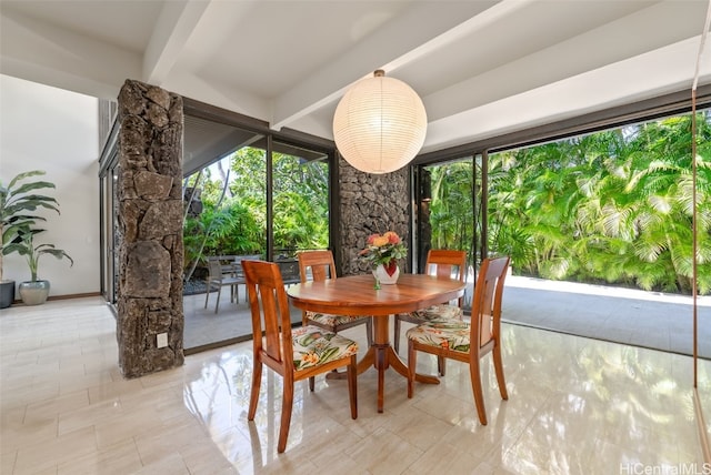 dining area with beam ceiling