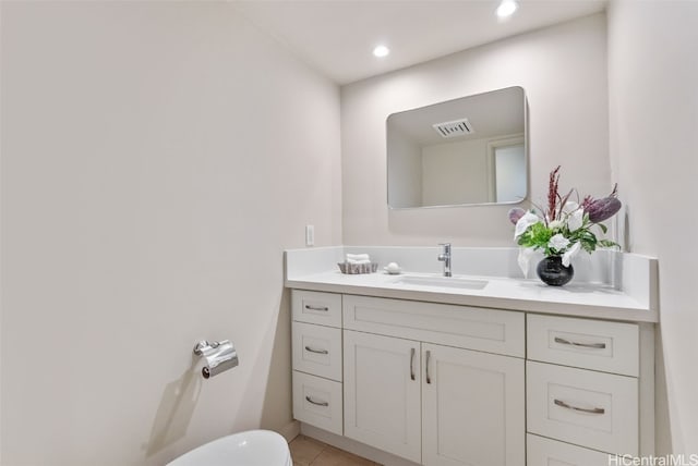 half bath with visible vents, toilet, tile patterned flooring, vanity, and recessed lighting