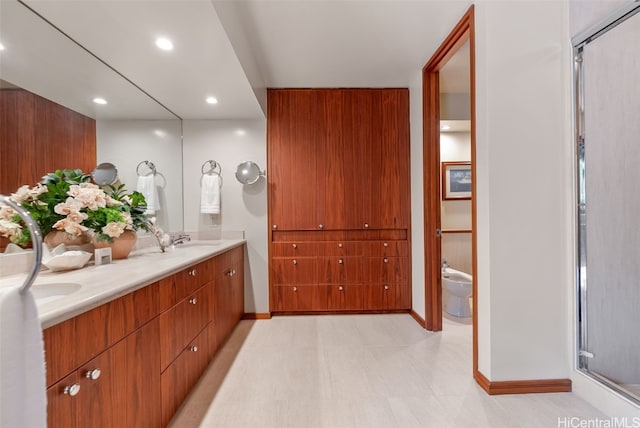 full bathroom with recessed lighting, a sink, baseboards, double vanity, and a stall shower