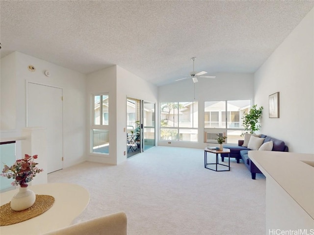 living room featuring vaulted ceiling, carpet flooring, plenty of natural light, and a textured ceiling