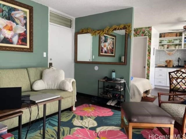 living area with a textured ceiling