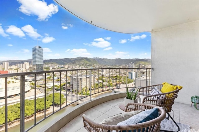 balcony with a mountain view and a city view