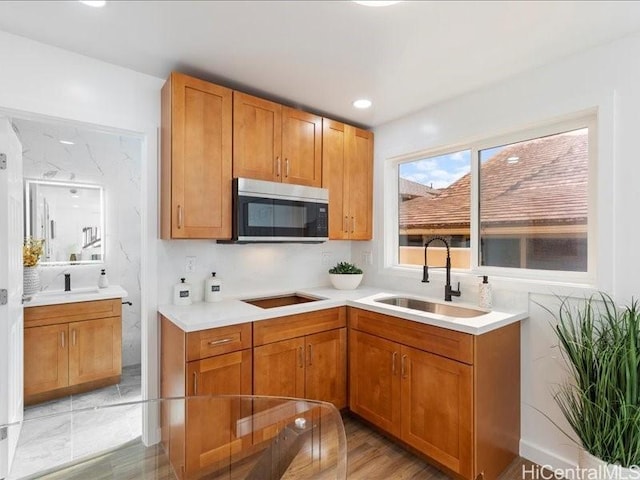 3503-A Wela St, Honolulu, HI 96815 - kitchen with stainless steel microwave, black electric stovetop, light countertops, brown cabinets, and recessed lighting