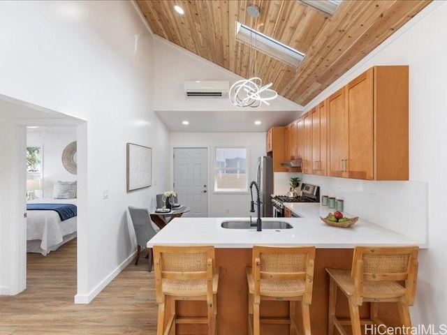 3503-A Wela St, Honolulu, HI 96815 - kitchen featuring stainless steel appliances, light wood-style floors, under cabinet range hood, light countertops, and wood ceiling