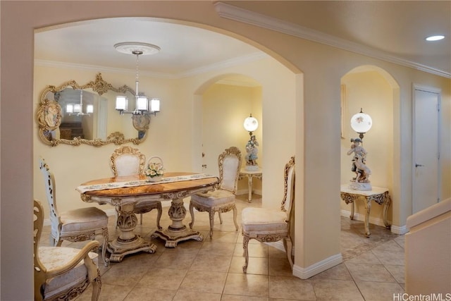 dining space with ornamental molding, a chandelier, baseboards, and light tile patterned floors