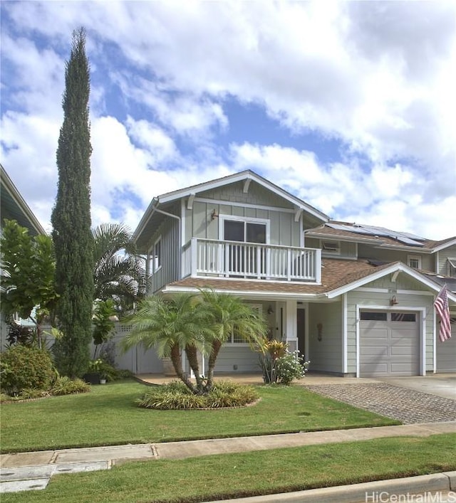 view of front of home with board and batten siding, a balcony, a garage, driveway, and a front lawn