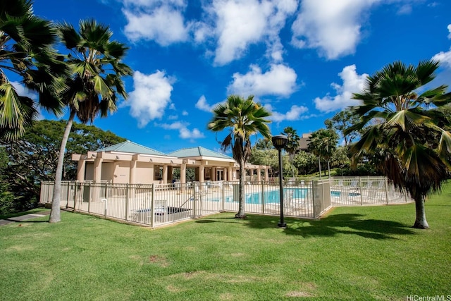 community pool featuring a yard, a patio, and fence