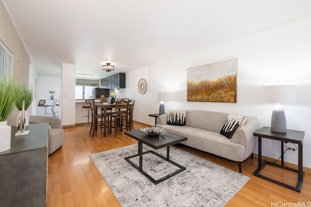 living room featuring light wood-style flooring and baseboards