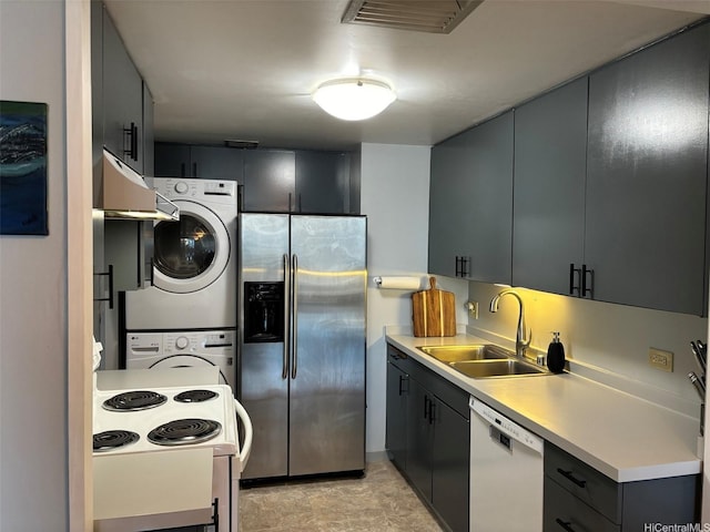 700 Richards St Unit 2403, Honolulu, HI 96813 - kitchen with light countertops, stacked washing maching and dryer, a sink, and white appliances