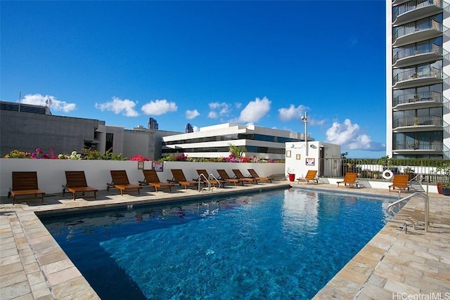 community pool featuring a patio area and fence