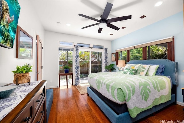 bedroom with dark wood finished floors, access to exterior, recessed lighting, and baseboards