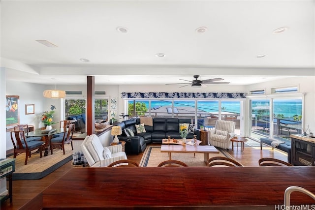 living room with recessed lighting, wood finished floors, and a wealth of natural light