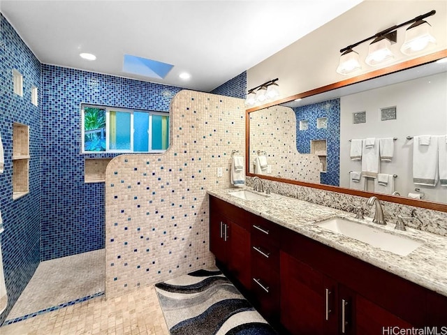 full bathroom with double vanity, recessed lighting, a walk in shower, and a sink