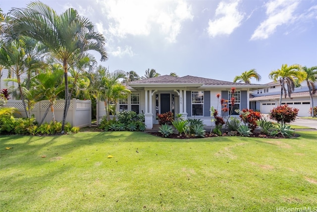 view of front facade featuring a garage, a front lawn, and fence