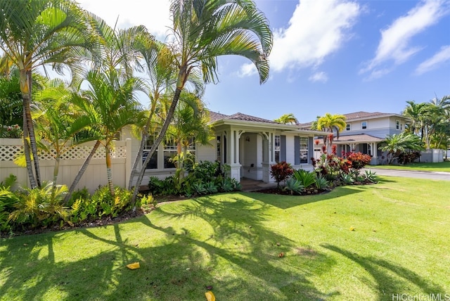 view of front of property with a front yard and fence