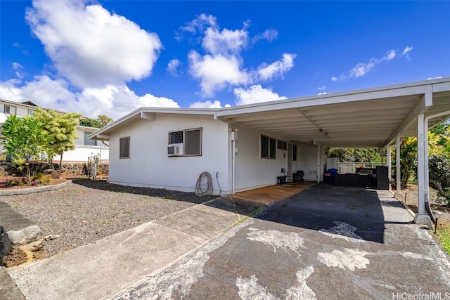 view of front of home featuring aphalt driveway and an attached carport