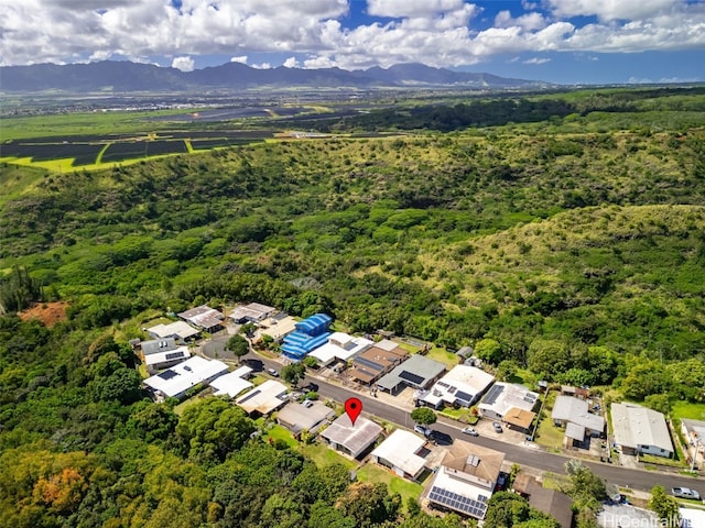 drone / aerial view featuring a residential view, a mountain view, and a wooded view