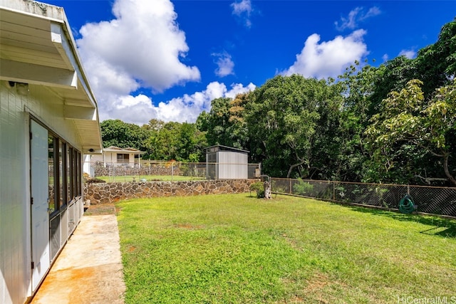 view of yard featuring a fenced backyard and an outdoor structure