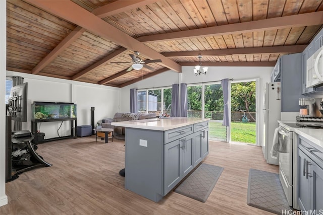 kitchen featuring lofted ceiling with beams, white appliances, open floor plan, light countertops, and gray cabinets