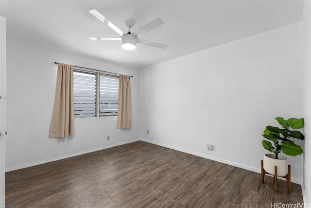 unfurnished room with a skylight, baseboards, a ceiling fan, and wood finished floors