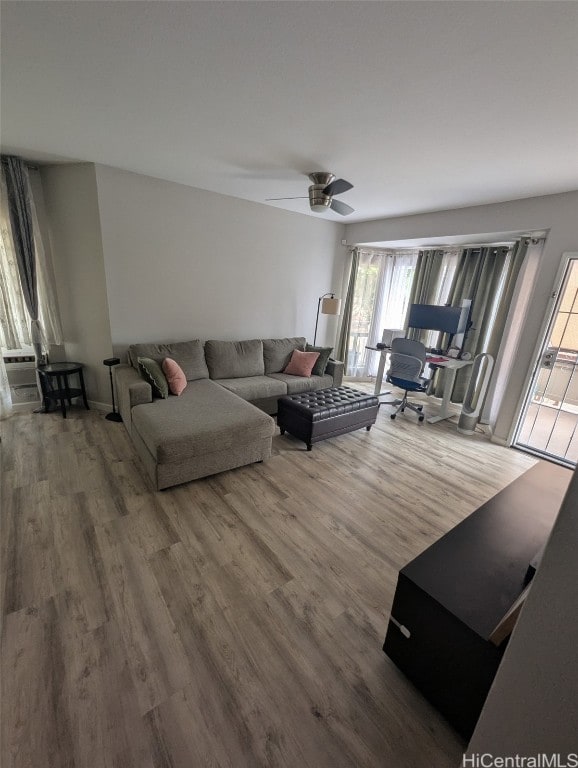 living room featuring a ceiling fan and wood finished floors