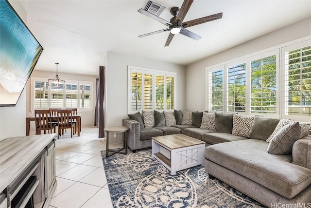 living room featuring light tile patterned floors and ceiling fan