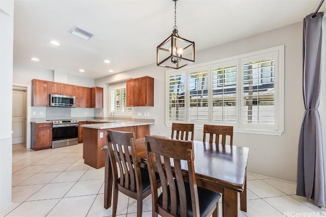 dining room with light tile patterned floors, visible vents, an inviting chandelier, and recessed lighting