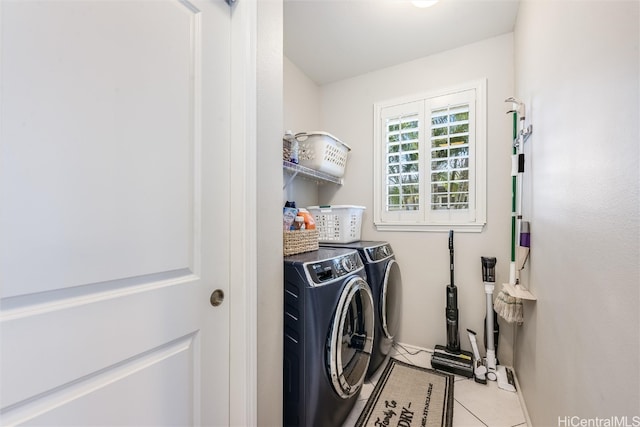 clothes washing area with light tile patterned floors, laundry area, and washer and dryer