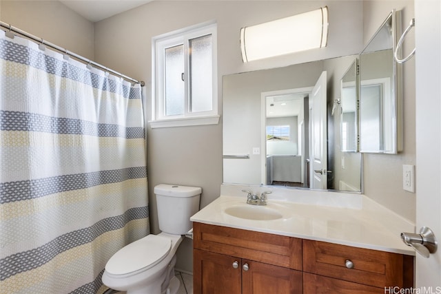 full bath with curtained shower, vanity, and toilet