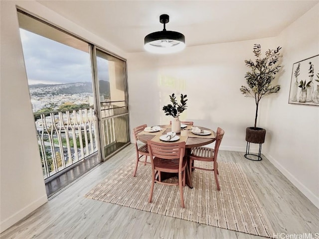 dining space with wood finished floors and baseboards