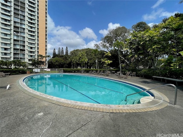 community pool with a patio area