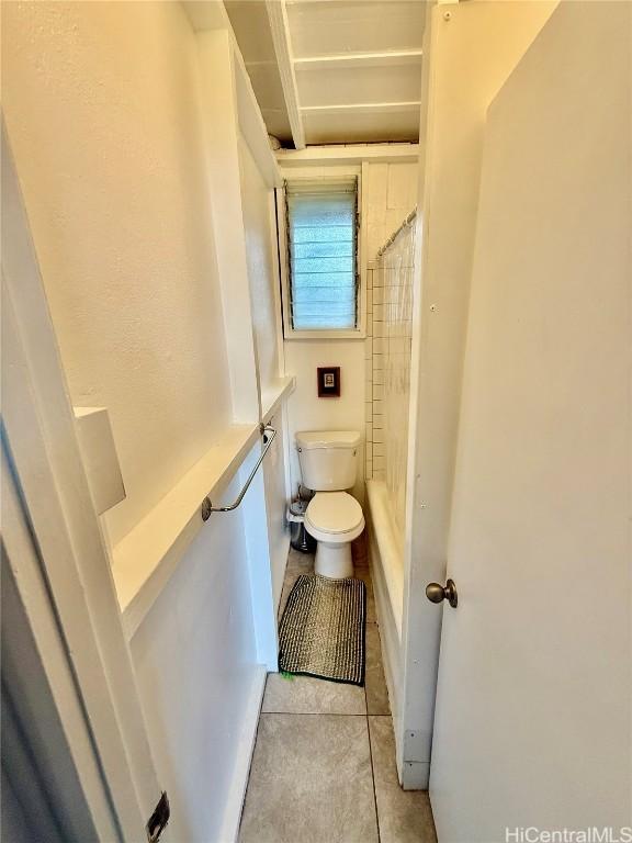 bathroom featuring toilet, tile patterned flooring, and walk in shower