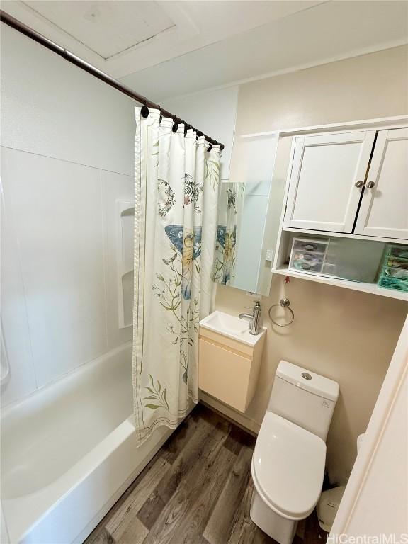 full bathroom featuring shower / tub combo with curtain, vanity, toilet, and wood finished floors