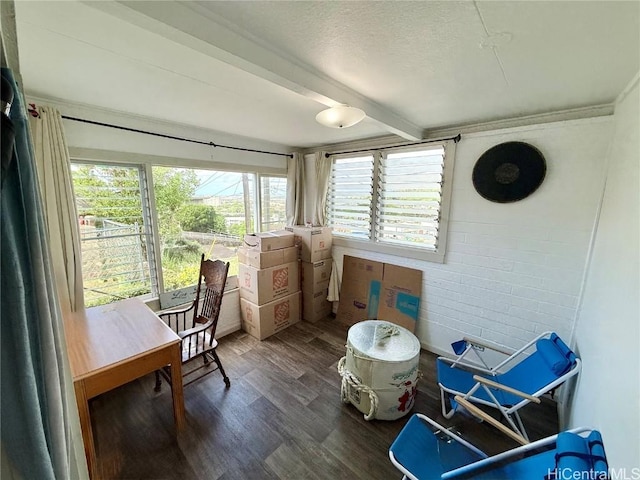 sunroom featuring beam ceiling