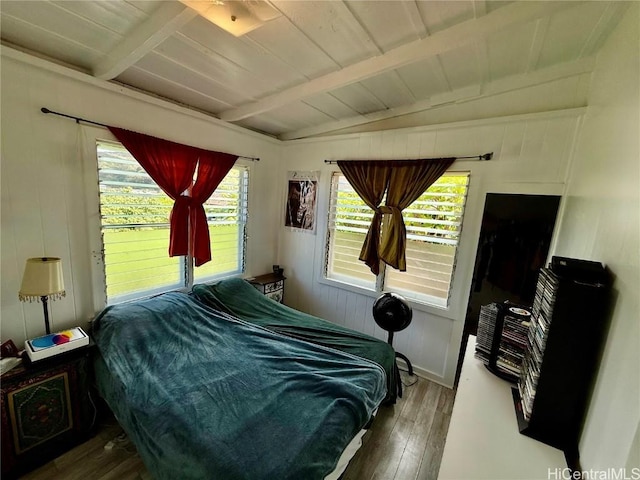 bedroom featuring wood ceiling, multiple windows, lofted ceiling with beams, and hardwood / wood-style floors