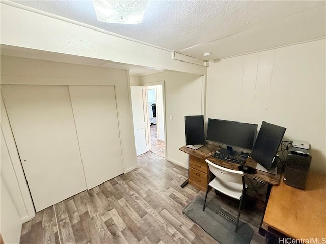 home office featuring a textured ceiling and wood finished floors