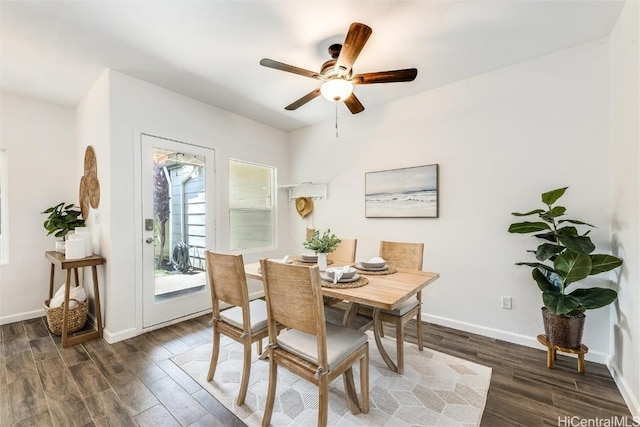 dining space with a ceiling fan, wood finished floors, and baseboards