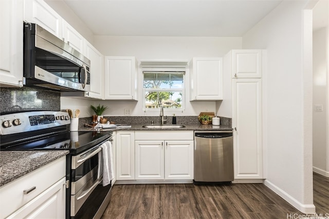 kitchen featuring a sink, white cabinets, dark wood finished floors, and stainless steel appliances