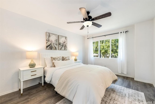 bedroom featuring dark wood-style floors, baseboards, and ceiling fan