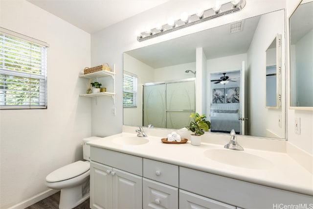 bathroom with a healthy amount of sunlight, a stall shower, and a sink