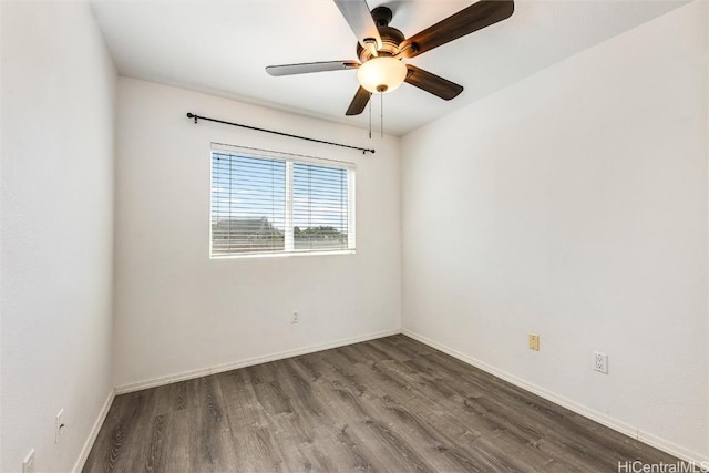 spare room featuring wood finished floors, baseboards, and ceiling fan