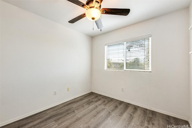 unfurnished room featuring ceiling fan, baseboards, and wood finished floors